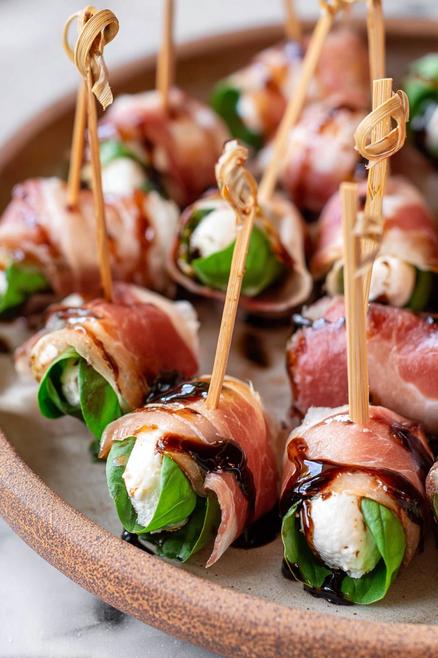 Prosciutto Mozzarella Bites with Basil, prosciutto appetizer, easy finger food, elegant party snacks, fresh basil appetizer - The image shows many small rolls arranged closely on a beige plate with a rustic look, all placed on a white marbled surface. Each roll has three visible layers: a dark green fresh basil leaf inside, a white creamy cheese layer wrapped around the leaf, and a thin, translucent pink cured meat layer folded around the outside. Each roll is pierced with a light brown wooden skewer with a small knot at the top, and a glossy dark brown balsamic glaze is lightly drizzled on top, adding a shiny, sticky texture. Photo taken with an iphone --ar 2:3 --v 7