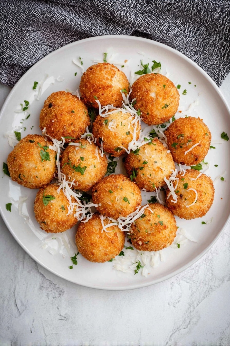 Cheddar and Green Onion Mashed Potato Balls, cheesy potato bites, crispy mashed potato snacks, savory potato appetizers, green onion potato balls - A close view of one bright golden brown fried ball being pulled apart by two woman's hands, revealing a soft, cheesy white inside with bits of green herbs mixed in, and a slight stringy cheese pull between the two halves. In the background, many more similar golden brown fried balls with small green herb pieces are scattered on a white plate, all set on a white marbled surface. photo taken with an iphone --ar 2:3 --v 7