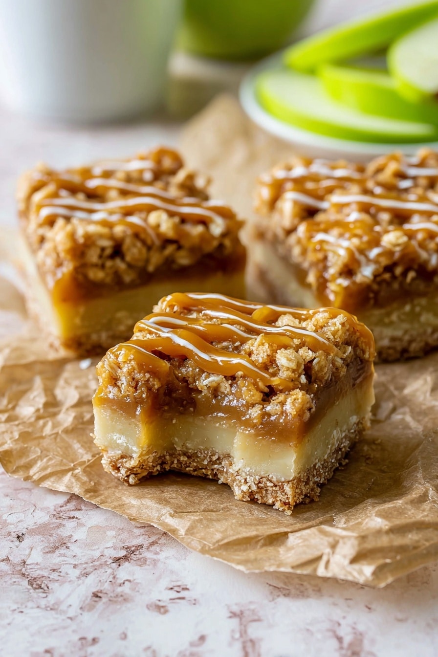 Salted Caramel Apple Pie Bars, apple pie bars with salted caramel, fall dessert recipes, caramel apple bars, easy apple dessert recipes - The image shows three square pieces of dessert bars on a crumpled piece of brown parchment paper resting on a white marbled surface. Each bar has three clear layers: a pale beige bottom layer that looks firm and smooth, a middle layer of light caramel filling, and a thick crumbly top layer coated with a shiny golden caramel drizzle. The crumbly top is textured with small oat pieces, giving a crunchy look. The bars are close together, with one piece having a bite taken out, showing the inside texture clearly. In the background, blurred green apple slices and a white cup are visible. Photo taken with an iphone --ar 2:3 --v 7