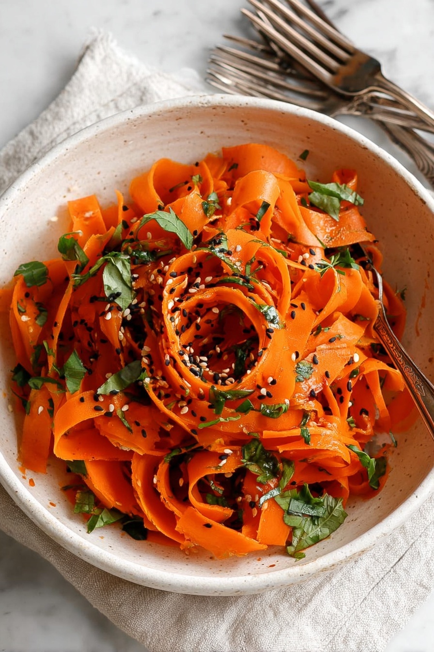 Raw Carrot Salad with Balsamic-Vinegar Dressing and Fresh Herbs, healthy carrot salad, quick veggie side dish, fresh herb salad, vegan carrot salad - A white bowl filled with thin, long orange carrot ribbons that are twisted and curled loosely in layers. The carrot ribbons have a shiny texture and are scattered with small pieces of green leafy herbs and black and white sesame seeds sprinkled on top. The bowl sits on a white marbled surface with a light cloth and two antique silver forks nearby. Photo taken with an iphone --ar 2:3 --v 7