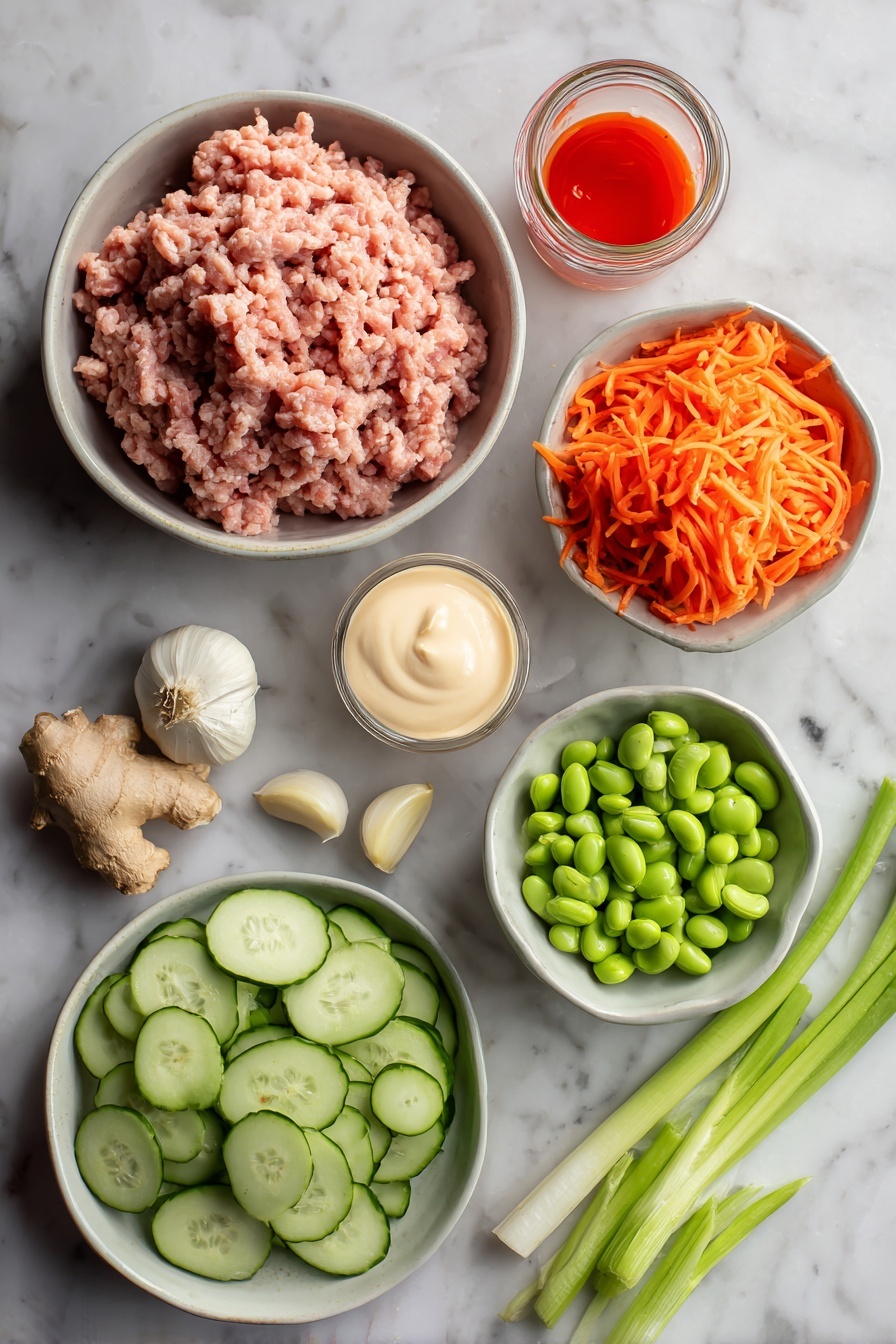 Ground Turkey Rice Bowls with Bang Bang Sauce, ground turkey rice bowls, spicy turkey rice bowl, quick dinner recipes, easy weeknight meals - Flat lay of ground turkey raw and fresh, peeled garlic cloves, fresh ginger root with a small piece grated, bright orange shredded carrots, sliced green onions with vibrant green tops, sliced avocado with creamy green flesh, shelled edamame beans, small jar of creamy mayonnaise, and a small bowl of bright red sweet chili sauce with sriracha drizzle, all placed on a white marble surface, photo taken with an iphone --ar 2:3 --v 7