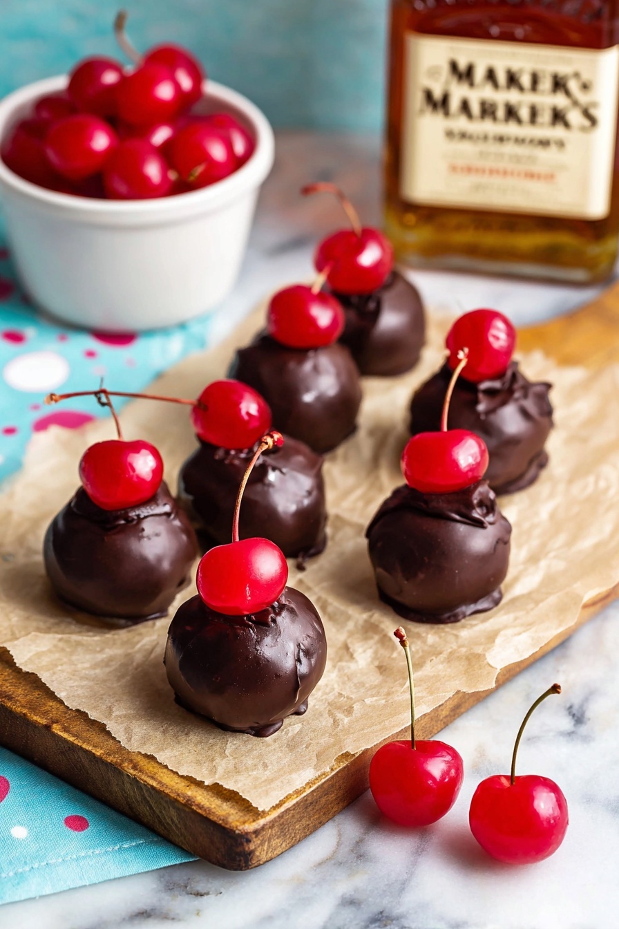 Cherry Bourbon Balls, bourbon cherry treats, chocolate cherry candies, adult holiday desserts, easy bourbon ball recipes - The image shows eight small round chocolate balls placed on light brown parchment paper over a white marbled surface. Each chocolate ball is topped with a shiny red cherry, some with stems attached, creating a bright red spot on the dark brown textured chocolate. Two extra shiny red cherries with long stems rest on the parchment paper near the chocolate balls. To the left, there is a small white bowl filled with more bright red cherries, and in the background, there is an out-of-focus Maker's Mark whiskey bottle on a wooden board, adding warm amber tones to the scene. The overall setting has a soft light blue cloth with white polka dots beneath the items, giving a fresh and inviting look. Photo taken with an iphone --ar 2:3 --v 7