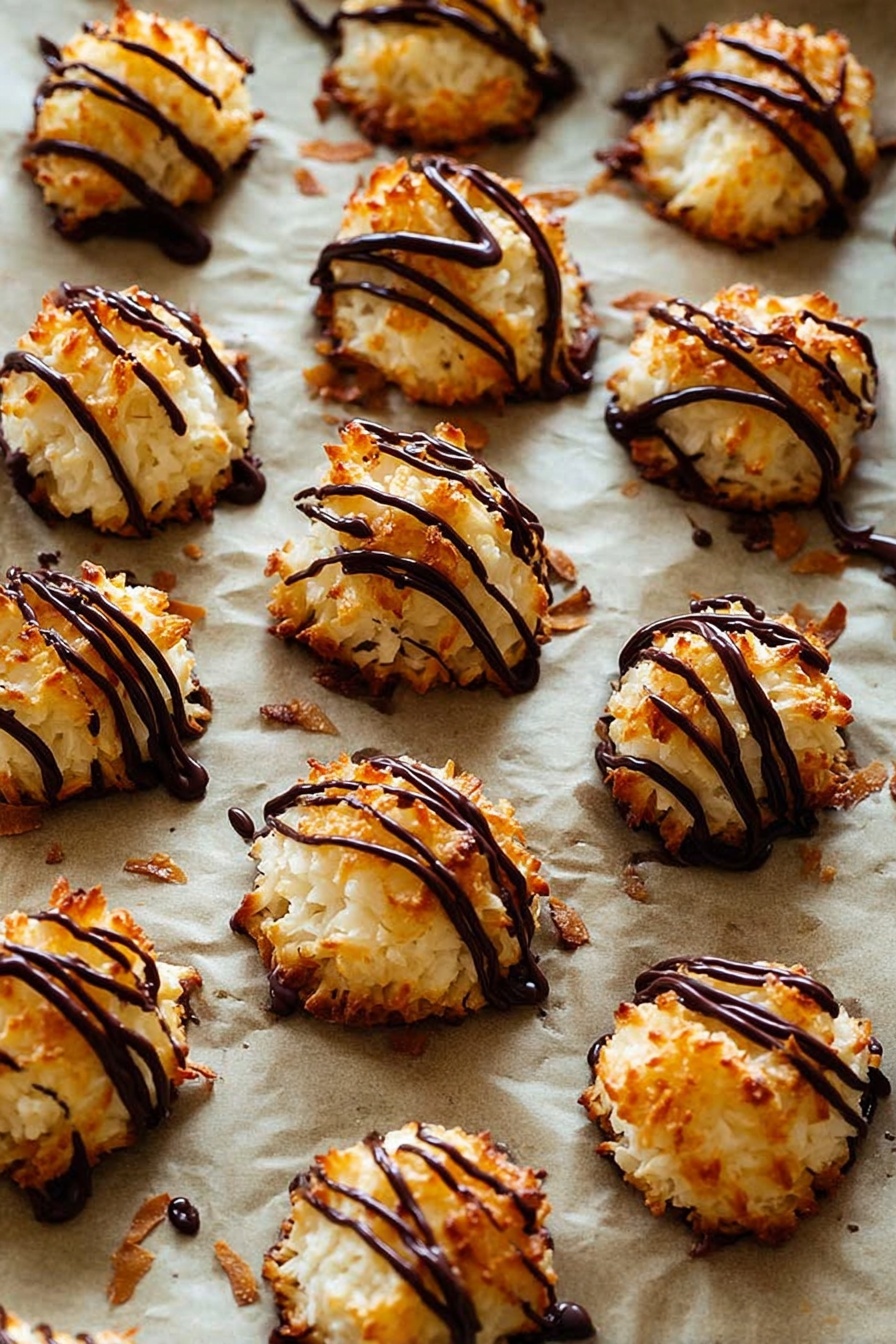 Coconut Macaroons with Condensed Milk, easy coconut macaroons, no-bake coconut treats, chewy coconut cookies, homemade coconut desserts - The image shows many small, round coconut macaroons with a golden-brown, slightly crispy texture on the outside and white inside. Each macaroon is topped with thin, shiny dark chocolate drizzle in irregular lines, adding a rich contrast in color and glossy texture. These treats are placed on a baking sheet lined with parchment paper that has a light brown color, and some small browned coconut flakes are scattered around. The background is a white marbled texture. photo taken with an iphone --ar 2:3 --v 7