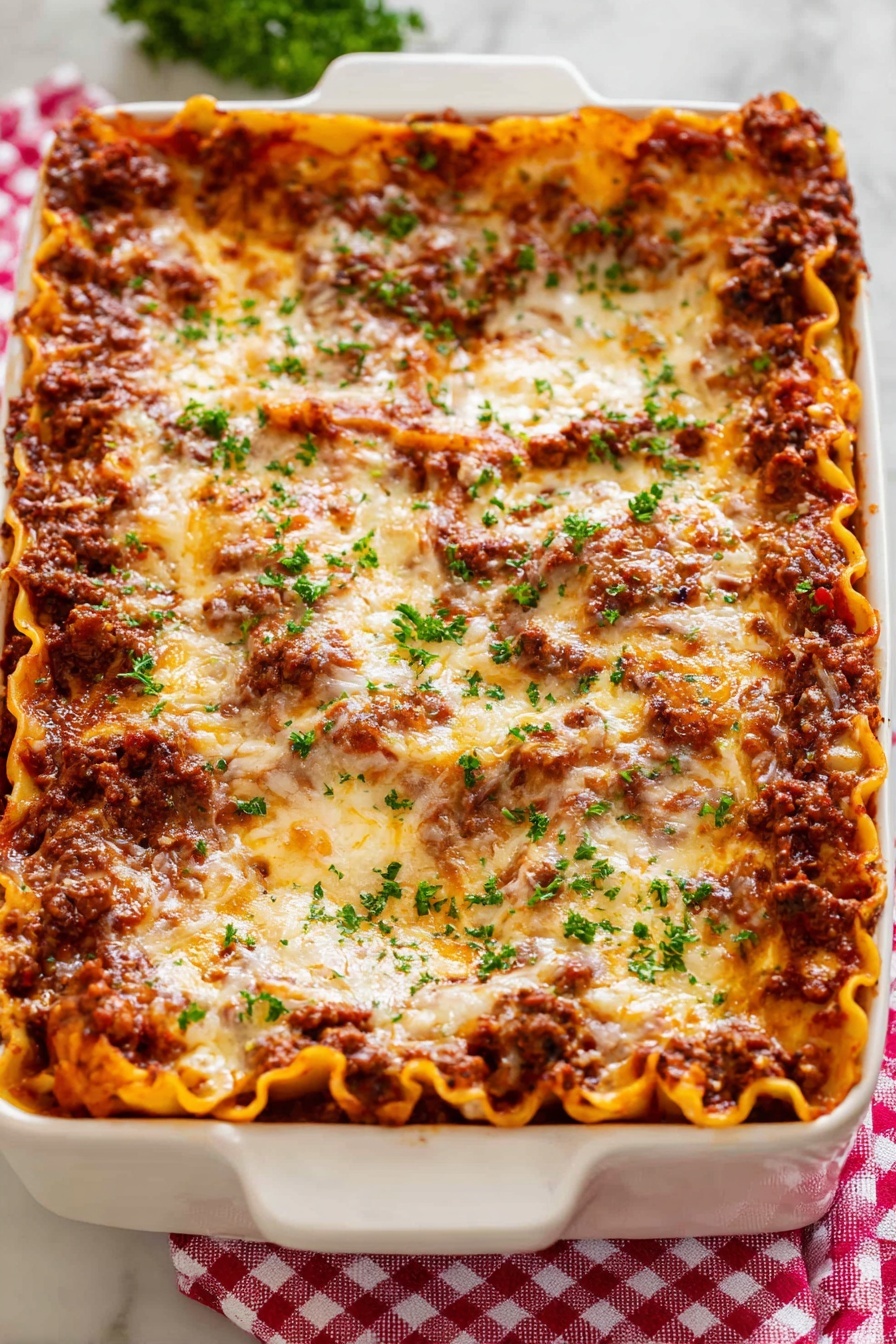 Classic Beef Lasagna, beef lasagna recipe, hearty lasagna, cheesy baked pasta, family dinner lasagna - A white rectangular baking dish holds a thick lasagna with about five layers visible; the bottom layer is flat orange pasta sheets, followed by a rich dark brown meat sauce, then another layer of pasta, meat sauce, and a top layer covered in melted golden cheese with brown spots. Small bits of fresh green parsley are sprinkled evenly on top, adding a fresh touch. The dish sits on a red and white checkered cloth over a white marbled surface. photo taken with an iphone --ar 2:3 --v 7