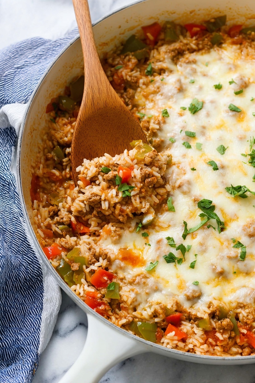 Stuffed Pepper Casserole with Sausage and Rice, stuffed pepper casserole, sausage and rice casserole, easy stuffed pepper casserole, hearty stuffed pepper dinner - This image shows a white pan filled with a cooked dish made of three main layers mixed together: cooked white rice grains, small pieces of green and red bell peppers, and browned ground meat in a light reddish sauce. On top, there is a melted layer of pale yellow cheese with a soft and slightly bubbly texture that spreads unevenly across the surface. Small chopped green herbs are sprinkled on top for a fresh touch. A wooden spoon is scooping some food from the left side. The pan is placed on a white marbled surface with a blue and white cloth under its handle. photo taken with an iphone --ar 2:3 --v 7