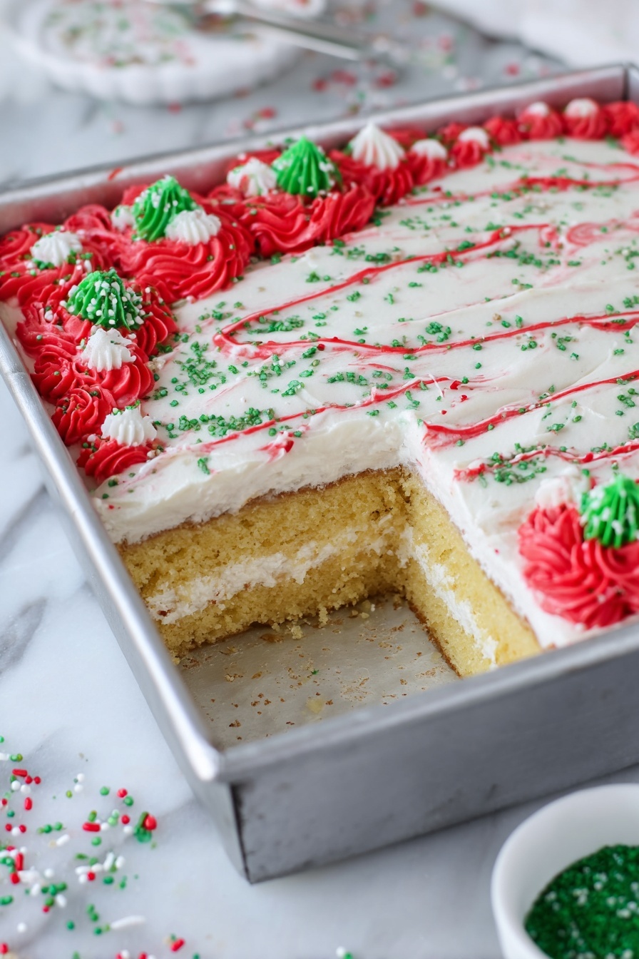 Christmas Tree Sheet Cake with White Chocolate Buttercream, festive holiday cake, Christmas cake recipe, white chocolate buttercream frosting, holiday dessert ideas - The image shows a square cake in a silver metal pan with a piece taken out from one corner, revealing two layers of golden-yellow cake separated by a thick white cream layer. The top layer of the cake is smooth and covered with white frosting, decorated with thin red lines curving across the surface, green sugar sprinkles scattered evenly, and clusters of red frosting rosettes at the edges with additional green and white sprinkle pieces on top. The pan is placed on a white marbled surface with a small white bowl containing green sugar nearby and some scattered red, green, and white sprinkles around. photo taken with an iphone --ar 2:3 --v 7