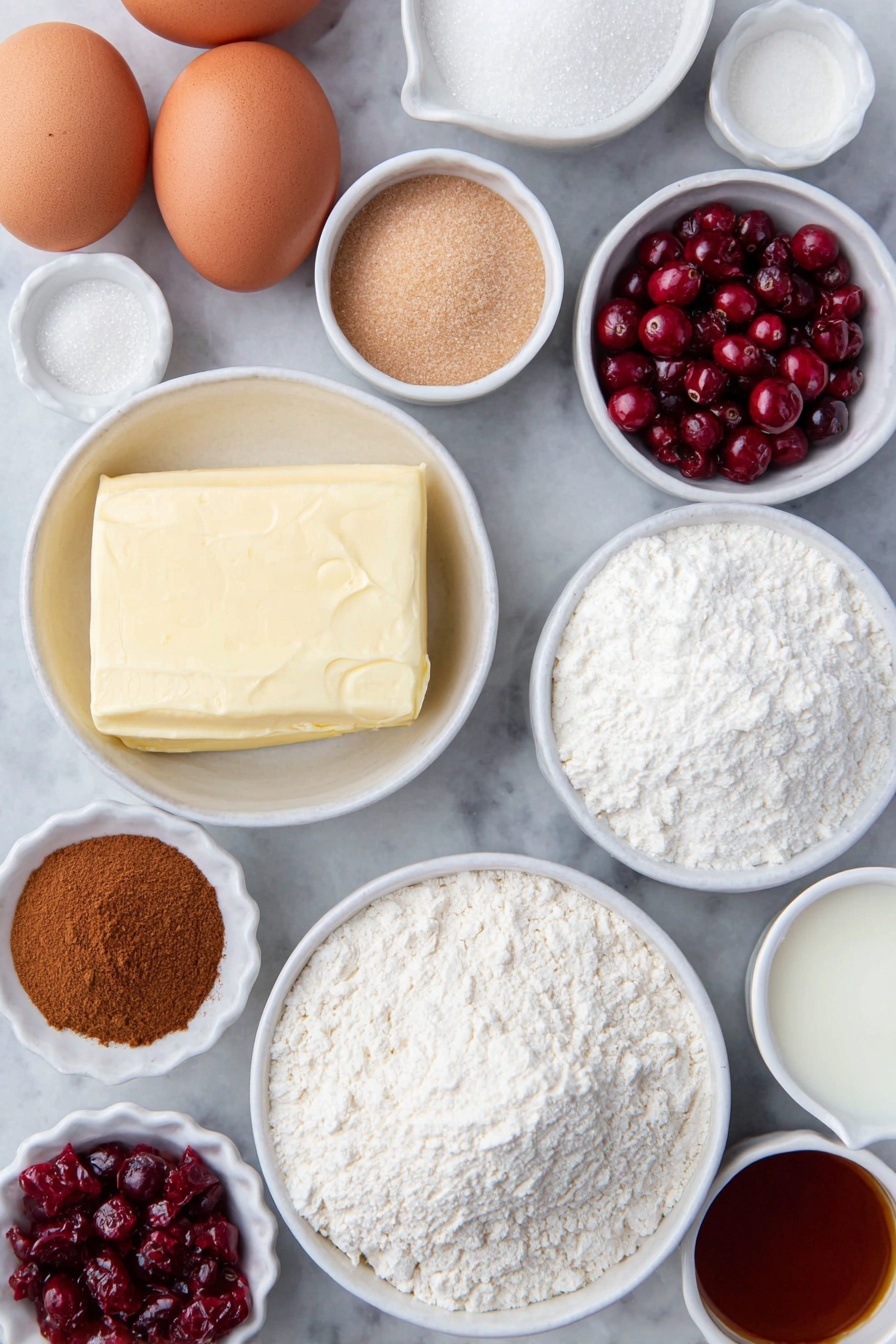 Cranberry Crumble Bars, cranberry dessert bars, tart and sweet bars, easy cranberry crumble, holiday cranberry treats - Flat lay of fresh unsalted butter in a small white ceramic bowl, two brown eggs with clean shells, a small white bowl filled with granulated sugar, a small white bowl of light brown packed sugar, a small white bowl of sifted powdered sugar, a small white bowl of all-purpose flour, a small white bowl of baking powder, a small white bowl of ground cinnamon, a small white bowl of kosher salt, a small white bowl of cornstarch, a handful of fresh bright red cranberries, a few strands of orange zest next to a small white bowl of fresh orange juice, a small white bowl of vanilla extract, and a small white bowl of whole milk, all evenly spaced and arranged symmetrically on a clean white marble surface, soft natural light, photo taken with an iPhone, professional food photography style, fresh ingredients, white ceramic bowls, no bottles, no duplicates, no utensils, no packaging --ar 2:3 --v 7 --p m7354615311229779997