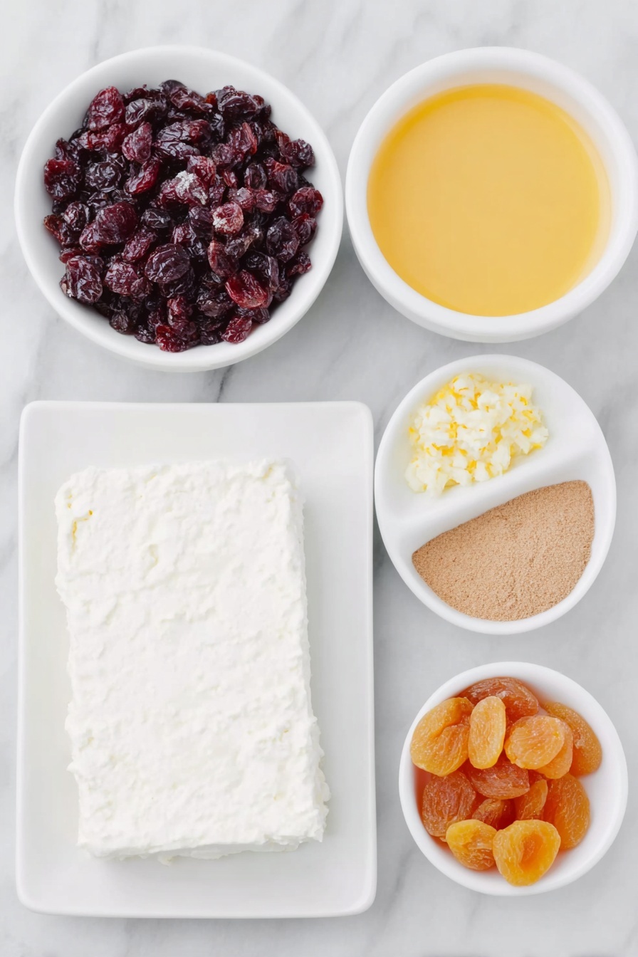Cranberry Orange Cream Cheese Spread, easy fruit cream cheese spread, holiday appetizer ideas, no-cook fruit spread, flavorful cheese dip - Flat lay of a block of fresh cream cheese on a simple white ceramic plate, a small white bowl filled with bright red chopped dried cranberries, a small white bowl with vibrant orange chopped dried apricots, another small white bowl containing fresh orange juice, a small white bowl with finely grated orange zest, and a tiny white bowl holding ground ginger powder, all arranged in perfect symmetry, placed on a clean white marble surface, soft natural light, photo taken with an iPhone, professional food photography style, fresh ingredients, white ceramic bowls, no bottles, no duplicates, no utensils, no packaging --ar 2:3 --v 7 --p m7354615311229779997