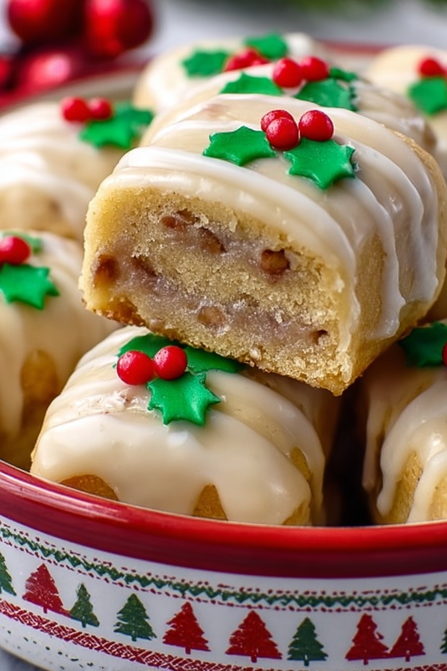 Gingerbread Yule Log Cookies, holiday gingerbread cookies, festive rolled gingerbread, Nutella-filled holiday cookies, Christmas gingerbread treats - A stack of square cookies with a light golden color and visible thin layers of a slightly darker filling inside, each topped with a thin, shiny glaze that looks creamy and smooth. On top of the front cookie, there is a small decoration made from green and red icing shaped like holly leaves and red berries. The cookies are placed inside a round white tin with a red pattern of reindeer and geometric shapes around the outside. The background shows more cookies and a white marbled surface beneath the tin. photo taken with an iphone --ar 2:3 --v 7